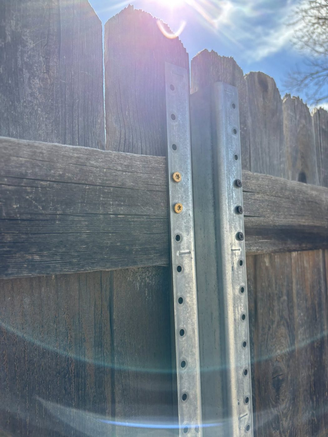 Steel post bracing on wood fence