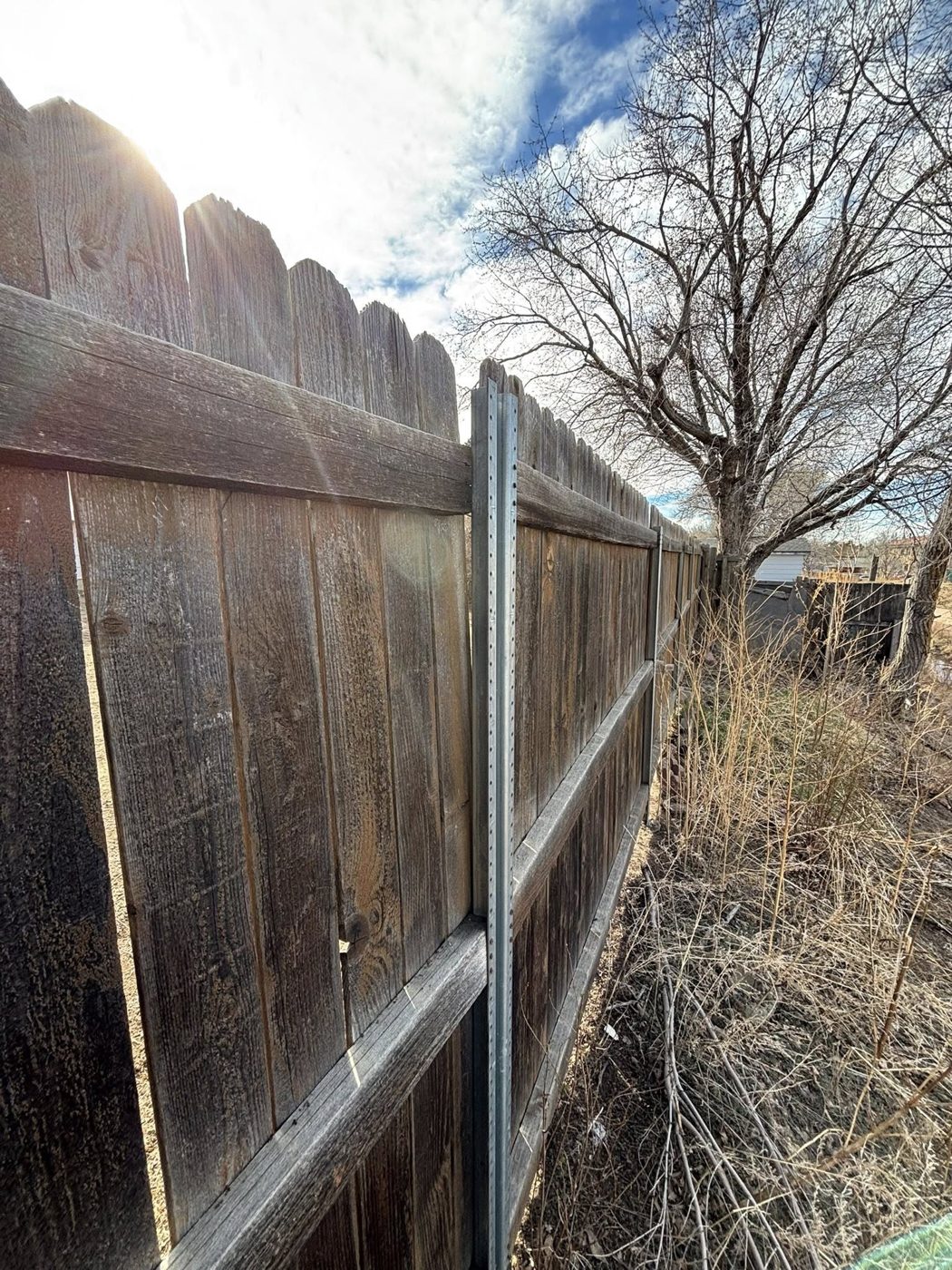 Repaired fence line with new post